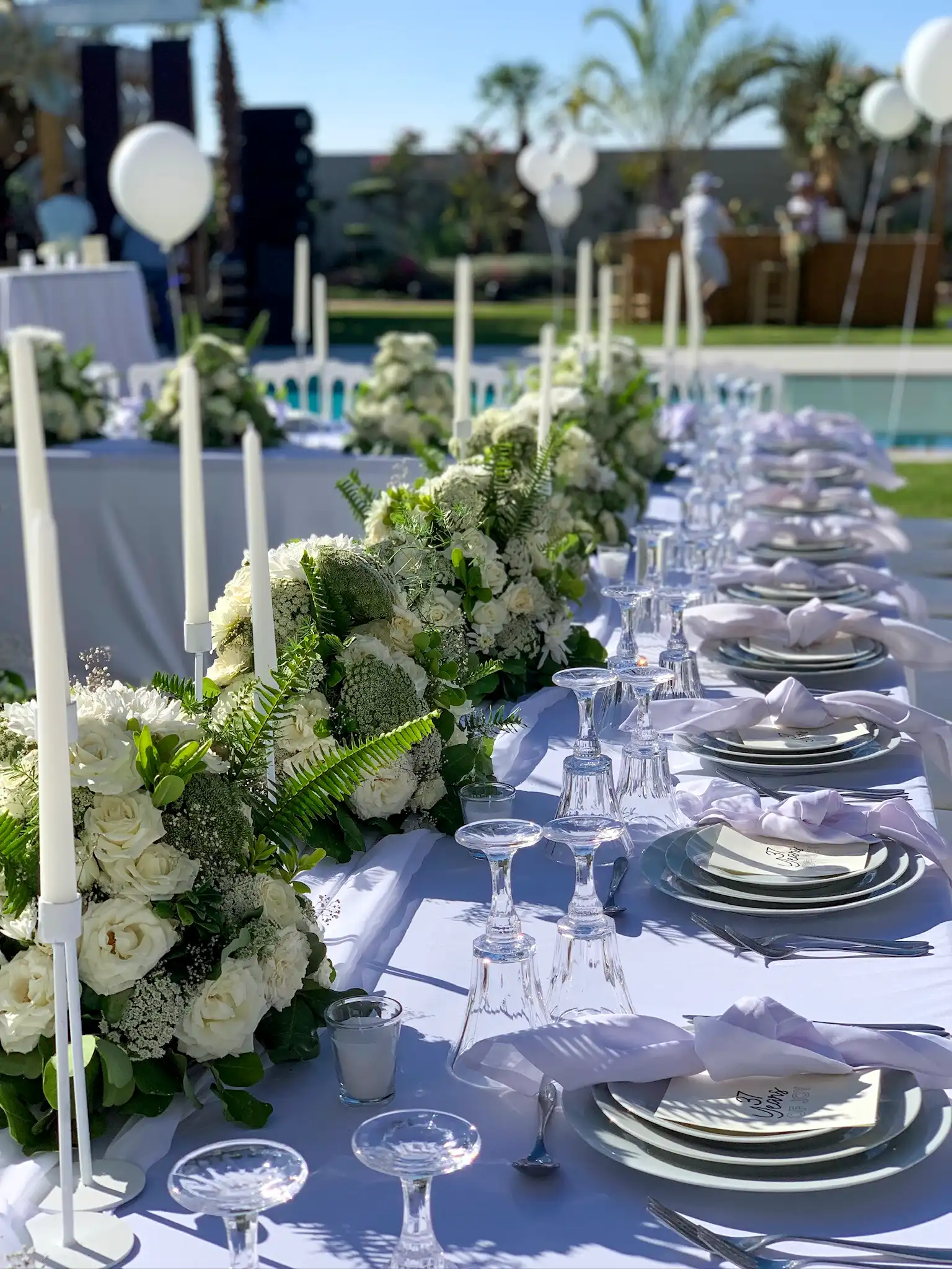 Luxury hen party setup in a private Marrakech villa garden with white florals by Rose Mirage